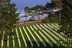 Graves of the fallen are seen with Omaha Beach in the background at the Normandy American Cemetery and Memorial, on September 27, 2013, at Colleville-sur-Mer, France. (Photo by Warrick Page - American Battle Monuments Commission)